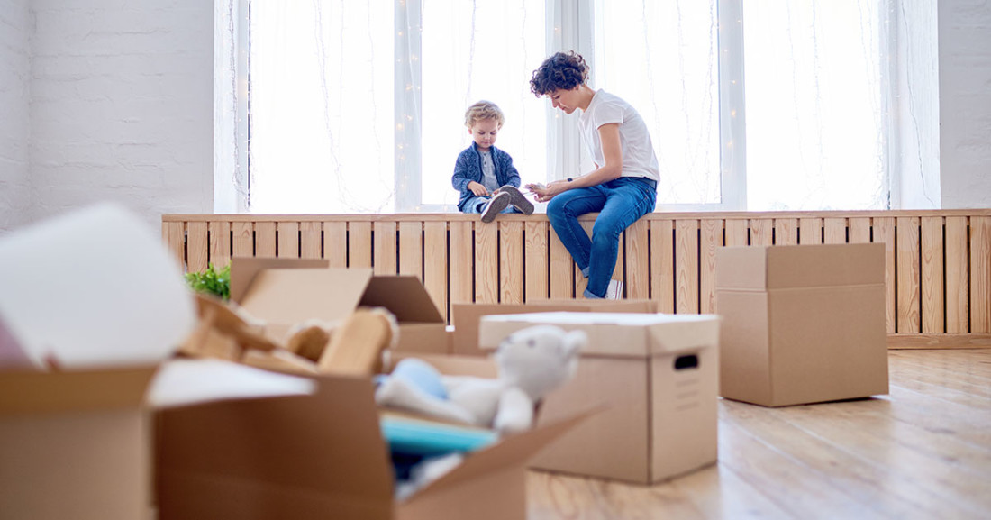 Relocation Mother with moving boxes and child